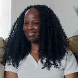 black woman standing beside white man talking